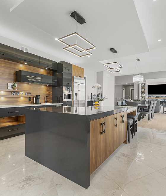 Modern kitchen with walnut cabinetry and a dark quartz island